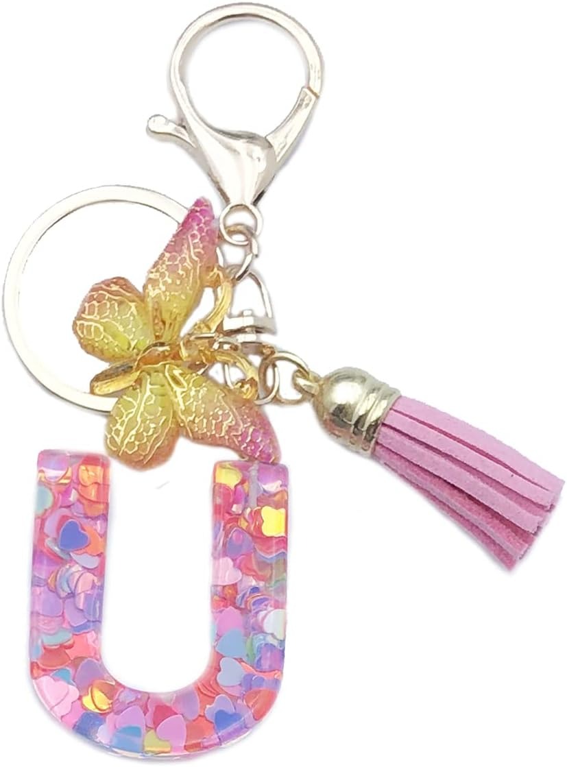 Keychain with letter 'U', butterfly, and pink tassel